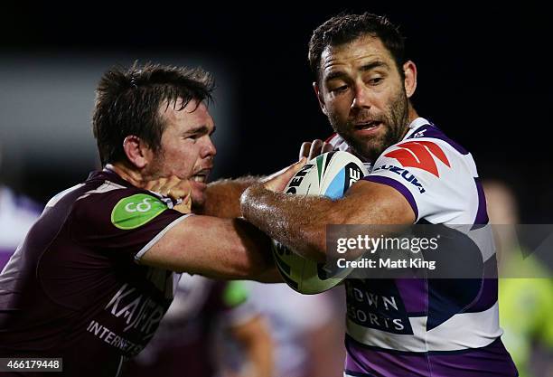 Cameron Smith of the Storm is tackled by Jamie Lyon of the Sea Eagles during the round two NRL match between the Manly Warringah Sea Eagles and the...