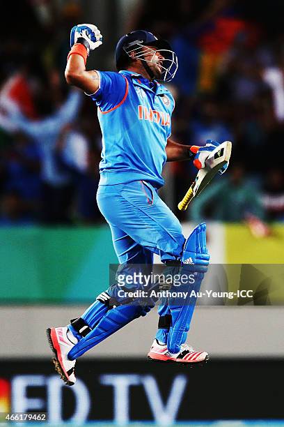 Suresh Raina of India celebrates after scoring a century during the 2015 ICC Cricket World Cup match between India and Zimbabwe at Eden Park on March...