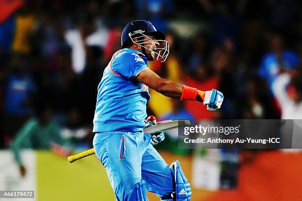 Suresh Raina of India celebrates after scoring a century during the 2015 ICC Cricket World Cup match between India and Zimbabwe at Eden Park on March...