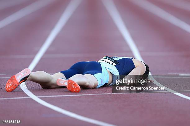 Louis Stenmark of New South Wales falls over on the finish line in the mens U18 400m during the Sydney Track Classic at Sydney Olympic Park on March...