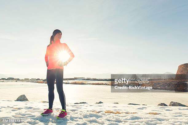 winter confidence - woman stretching sunset stockfoto's en -beelden