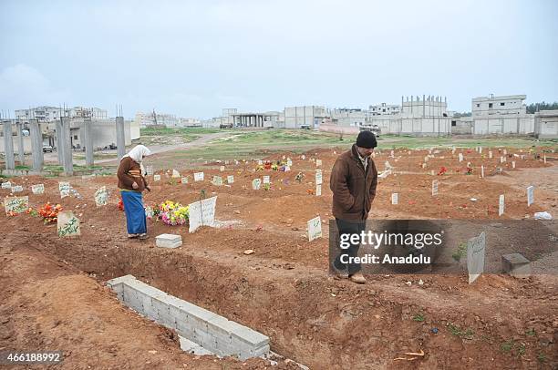 Artificial flowers are seen on the graves of Syrians who lost their lives during clashes in Kobani, Syria on March 12, 2015. Following around 4...