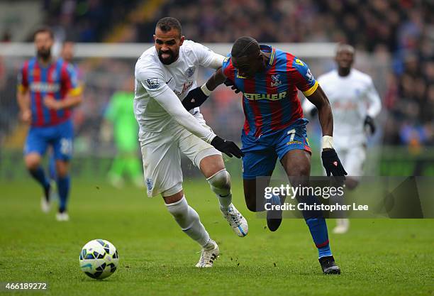Yannick Bolasie of Crystal Palace takes on Sandro of QPR during the Barclays Premier League match between Crystal Palace and Queens Park Rangers at...
