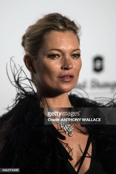 British model Kate Moss arrives on the red carpet during the 2015 amfAR Hong Kong gala at Shaw Studios in Hong Kong on March 14, 2015. AmfAR, the...