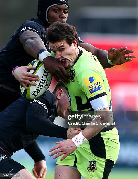 Lee Dickson of Northampton is tackled by Saracens' Ben Spencer and Maro Itoje during the LV= Cup Semi Final match between Saracens and Northampton...