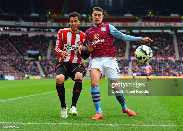 Ricardo Alvarez of Sunderland and Matthew Lowton of Aston Villa battle for the ball during the Barclays Premier League match between Sunderland and...