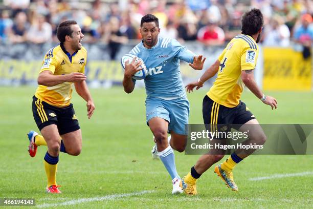 Benji Marshall of the Blues hits the defence of Tim Bateman and Andre Taylor of the Hurricanes during the Super Rugby Trial Match between the Blues...