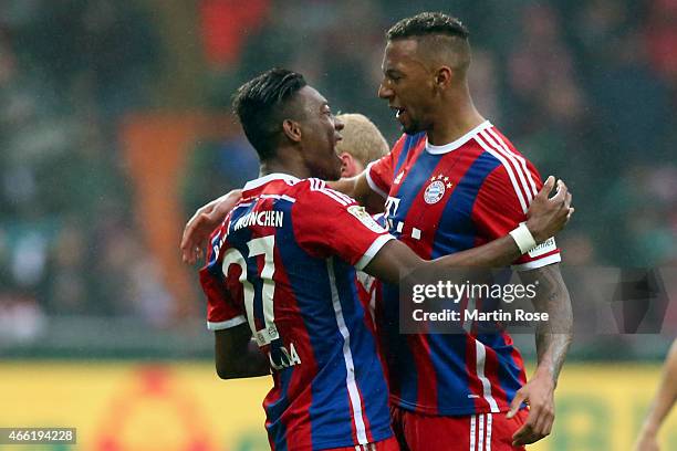David Alaba of Muenchen celebrates scoring the 2nd goal with his team mate Jerome Boateng during the Bundesliga match between SV Werder Bremen and FC...