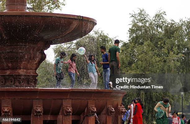 Students enjoying cloudy weather at India gate, on March 14, 2015 in New Delhi, India. The Met Office has forecast a cloudy day. (