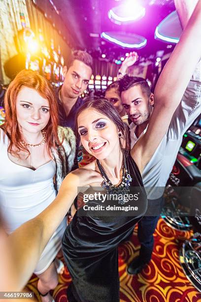 group of friends gets a selfie inside the casino - male model selfie stock pictures, royalty-free photos & images