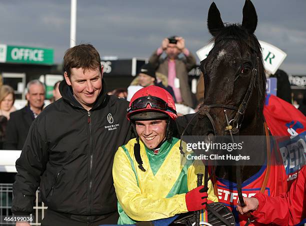 Jonathan Burke riding Goonyella celebrates after winning the Betfred Midlands Grand National Steeple Chase at Uttoxeter Racecourse on March 14, 2015...