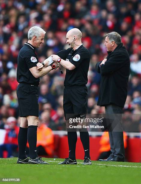 Fourth official Anthony Taylor replaces referee Chris Foy during the Barclays Premier League match between Arsenal and West Ham United at Emirates...
