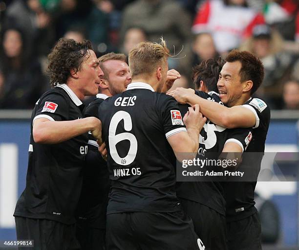 Shinji Okazaki of FSV Mainz 05 congratulates Ja-Cheol Koo after he scores the second goal during the Bundesliga match betwen FC Augsburg and FSV...