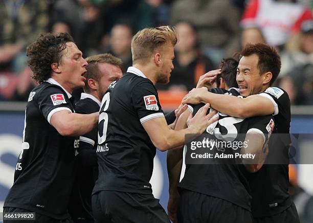 Shinji Okazaki of FSV Mainz 05 congratulates Ja-Cheol Koo after he scores the second goal during the Bundesliga match betwen FC Augsburg and FSV...