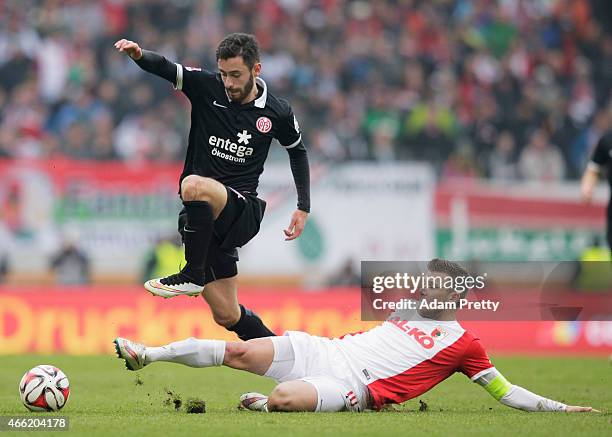 Daniel Baier of FC Augsburg tackles Yunus Malli of FSV Mainz 05 during the Bundesliga match betwen FC Augsburg and FSV Mainz 05 at SGL Arena on March...