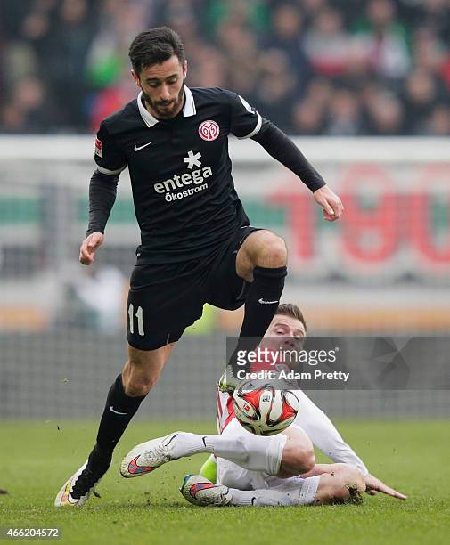 Daniel Baier of FC Augsburg tackles Yunus Malli of FSV Mainz 05 during the Bundesliga match betwen FC Augsburg and FSV Mainz 05 at SGL Arena on March...