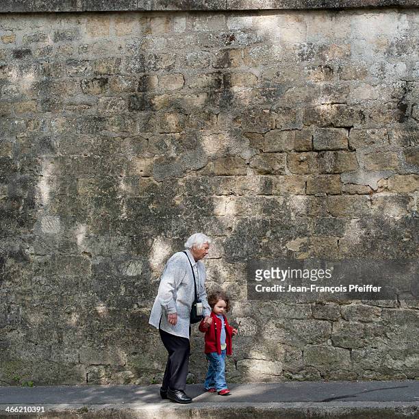 little girl with grandmother holding hands - ile de france stock pictures, royalty-free photos & images