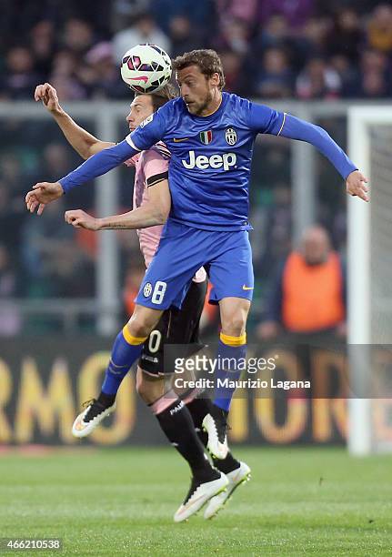 Franco Vazquez of Palermo competes for the ball in air with Claudio Marchisio of Juventus during the Serie A match between US Citta di Palermo and...