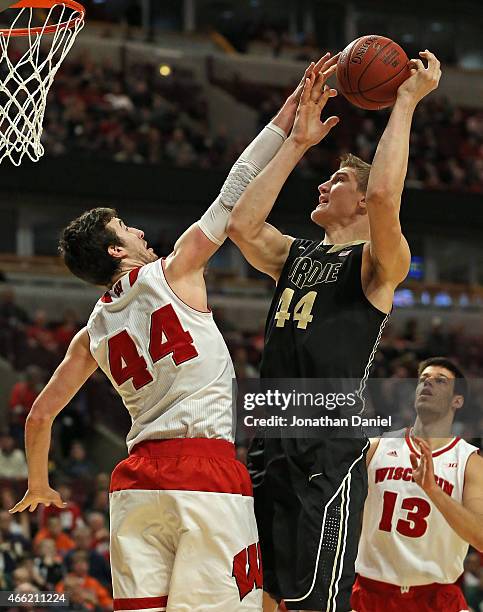 Frank Kaminsky#44 of the Wisconsin Badgers blocks a shot by Isaac Haas of the Purdue Boilermakers during the semifinal round of the 2015 Big Ten...