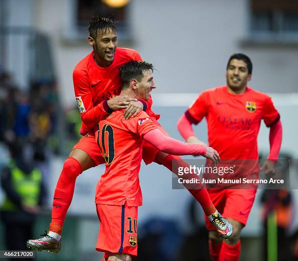 Lionel Messi of FC Barcelona celebrates with his teammate Neymar of ...
