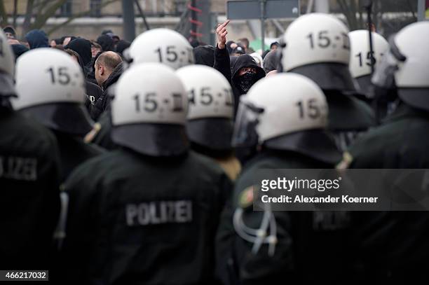 Supporter of Pegida gestures towards police forces during a public gathering on March 14, 2015 in Wuppertal, Germany. Several hundred Salafis, who in...