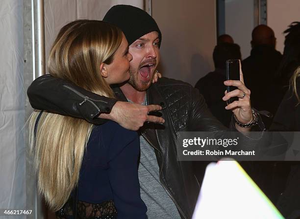 Lauren Parsekian and Aaron Paul attend the ESPN The Party at Basketball City - Pier 36 - South Street on January 31st, 2014 in New York City
