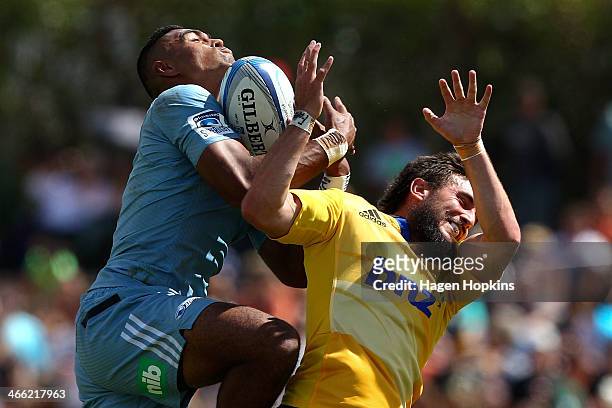 Lolagi Visinia of the Blues and Andre Taylor of the Hurricanes compete for a high ball during the Super Rugby Trial Match between the Blues and the...