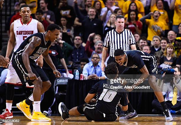 Terry Larrier celebrates a foul with Jonathan Williams of the Virginia Commonwealth Rams during a semifinal game against the Davidson Wildcats in the...