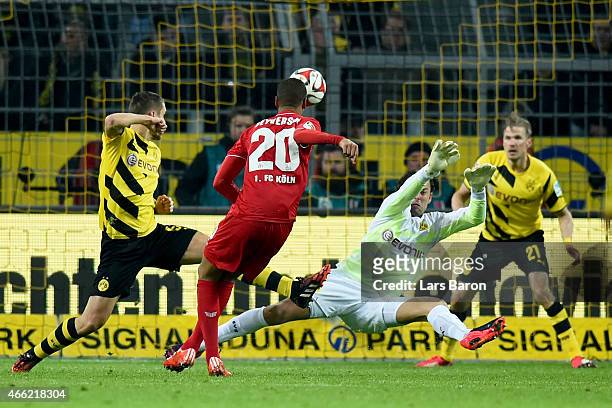Sebastian Kehl of Dortmund and his team mate keeper Roman Weidenfeller battle for the ball with Deyverson Brum Silva Acosta of Koeln during the...