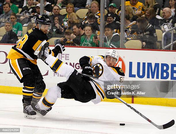 Kris Letang of the Pittsburgh Penguins checks Brad Marchand of the Boston Bruins in the second period during the game at Consol Energy Center on...