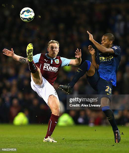 Scott Arfield of Burnley and Fernandinho of Manchester City battle for the ball during the Barclays Premier League match between Burnley and...