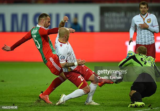 Petar Skuletic of FC Lokomotiv Moscow challenged by Lukas Tesak and Jan Mucha of Arsenal Tula during the Russian Premier League match between FC...