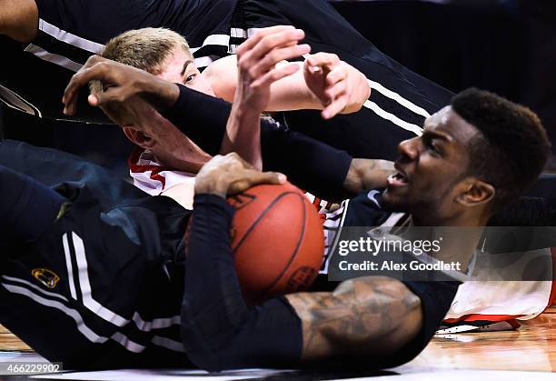 Oskar Michelsen of the Davidson Wildcats fights for the ball with JeQuan Lewis of the Virginia Commonwealth Rams during a semifinal game in the 2015...