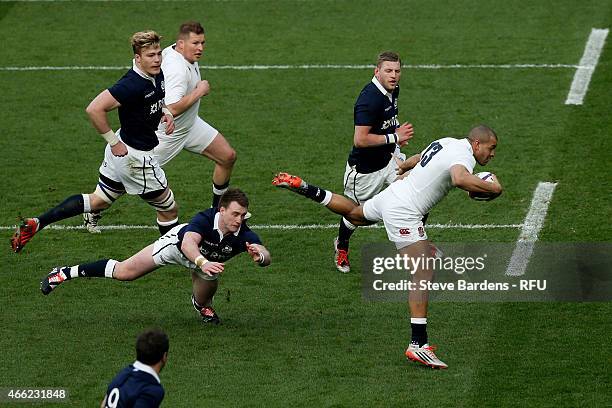 Jonathan Joseph of England breaks through the tackle from Stuart Hogg of Scotland to score the opening try during the RBS Six Nations match between...