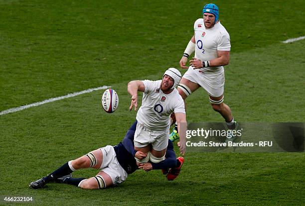 Dave Attwood of England offloads as he is tackled by Rob Harley of Scotland during the RBS Six Nations match between England and Scotland at...