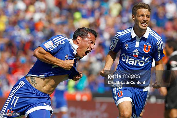 Sebastian Ubilla and Maximiliano Rodriguez of Universidad de Chile celebrate after scoring the first goal of his team during a match between U de...