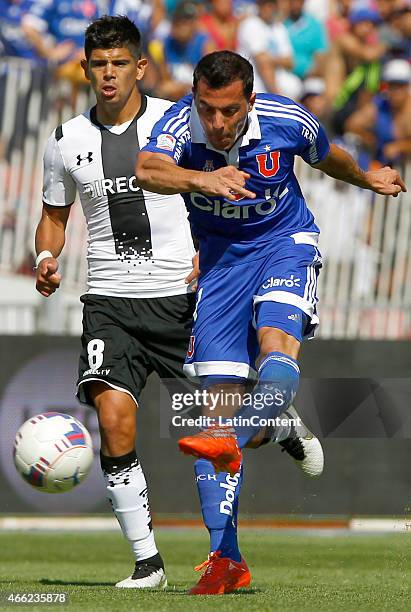 Sebastian Ubilla of Universidad de Chile kicks the ball to score the first goal during a match between U de Chile and Colo Colo as part of round 11...