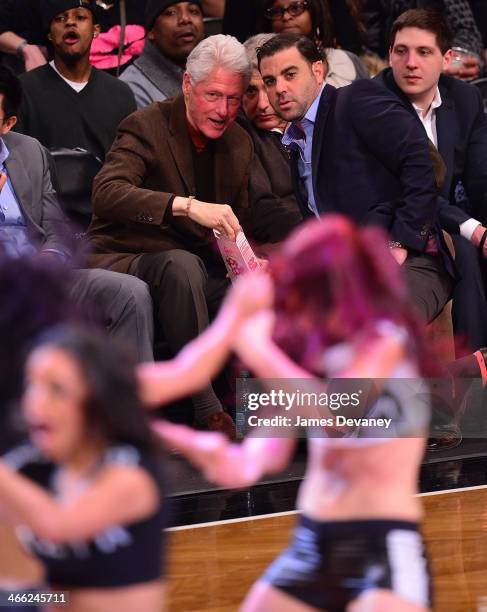 Former US President Bill Clinton attends the Oklahoma City Thunder vs Brooklyn Nets game at Barclays Center on January 31, 2014 in the Brooklyn...