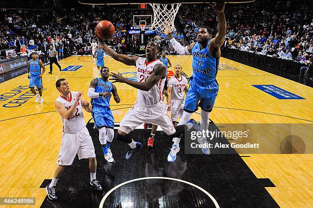 Jordan Sibert of the Dayton Flyers attempts a shot under Hassan Martin of the Rhode Island Rams during a semifinal game in the 2015 Men's Atlantic 10...