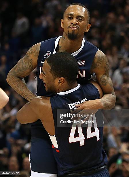 Ryan Boatright of the Connecticut Huskies celebrates with Rodney Purvis after defeating Tulsa Golden Hurricanes during the semifinal game of the 2015...