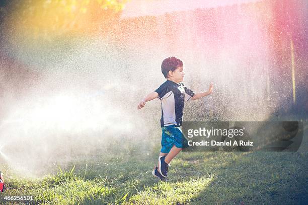 boy chased by light and water - alpharetta stock pictures, royalty-free photos & images