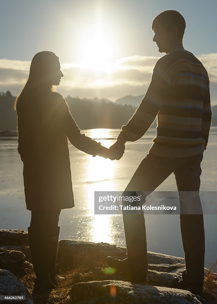 Happy romantic couple holding hands