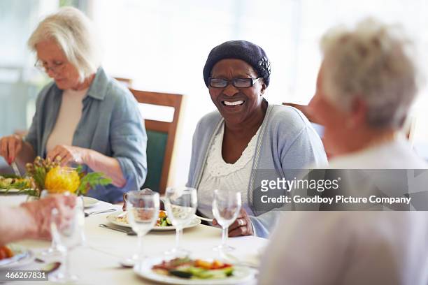 friendly laughs at lunchtime - assisted living community stock pictures, royalty-free photos & images