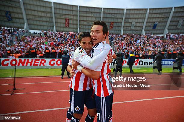 Erick Torres of Chivas celebrates with teammates after scoring the first goal of his team during a match between Puebla and Chivas as part of 10th...