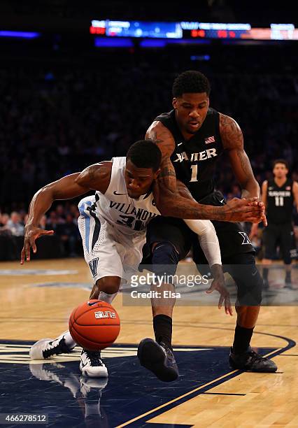 Dylan Ennis of the Villanova Wildcats drives to the basket as Jalen Reynolds of the Xavier Musketeers defends during the championship game of the Big...