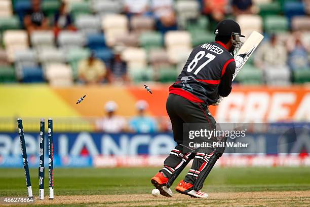 Mohammad Naveed of the United Arab Emirates is bowled by Andre Russell of West Indies during the 2015 ICC Cricket World Cup match between the West...