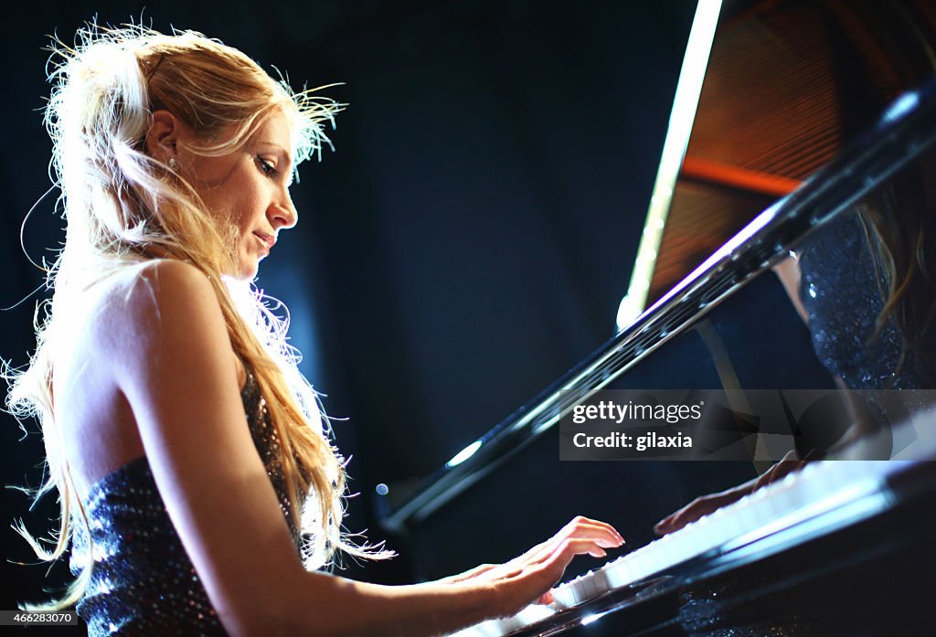 Female piano soloist in a concert.