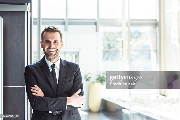 happy businessman in an office - hotel manager stockfoto's en -beelden