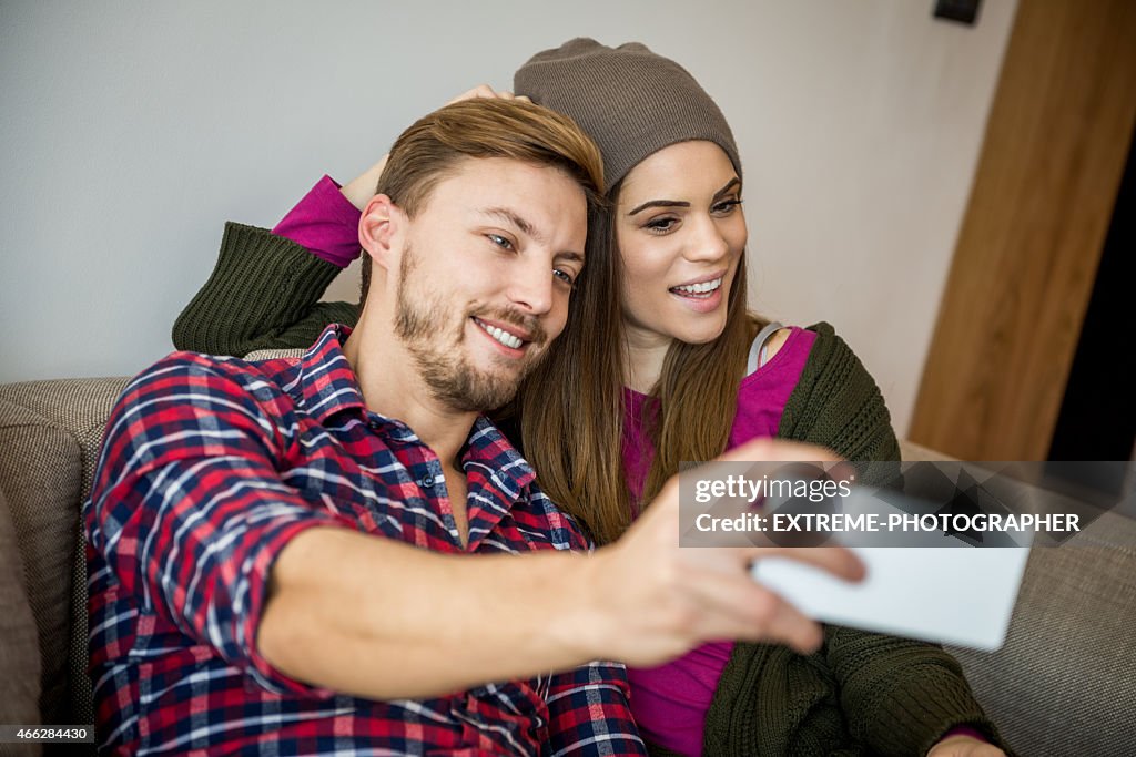 Young couple taking a selfie in livingroom