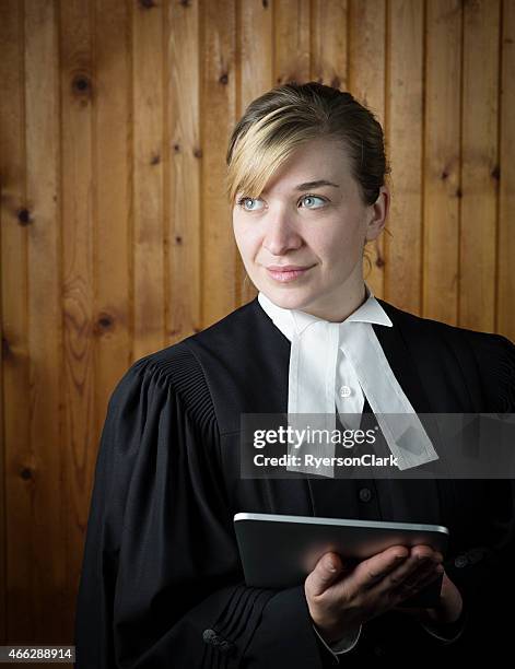 barrister or lawyer in traditional robes with an electronic notebook - robe stockfoto's en -beelden